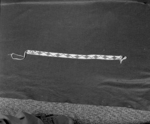 Marie Rozier Collection, Catalog No. 137. Object: Miwok beaded hatband. Dimensions: 21 x 1". Materials: Cotton thread; white, green, red and yellow beads. Technology: Made by Mrs. Louise Fuentes in 1950s. Collection History: Purchased from Mrs. Fuentes. Photographed by Michael Dixon in December 1982. Catalogued by Craig Bates and Barbara Beroza. Yosemite Collections, National Park Service.