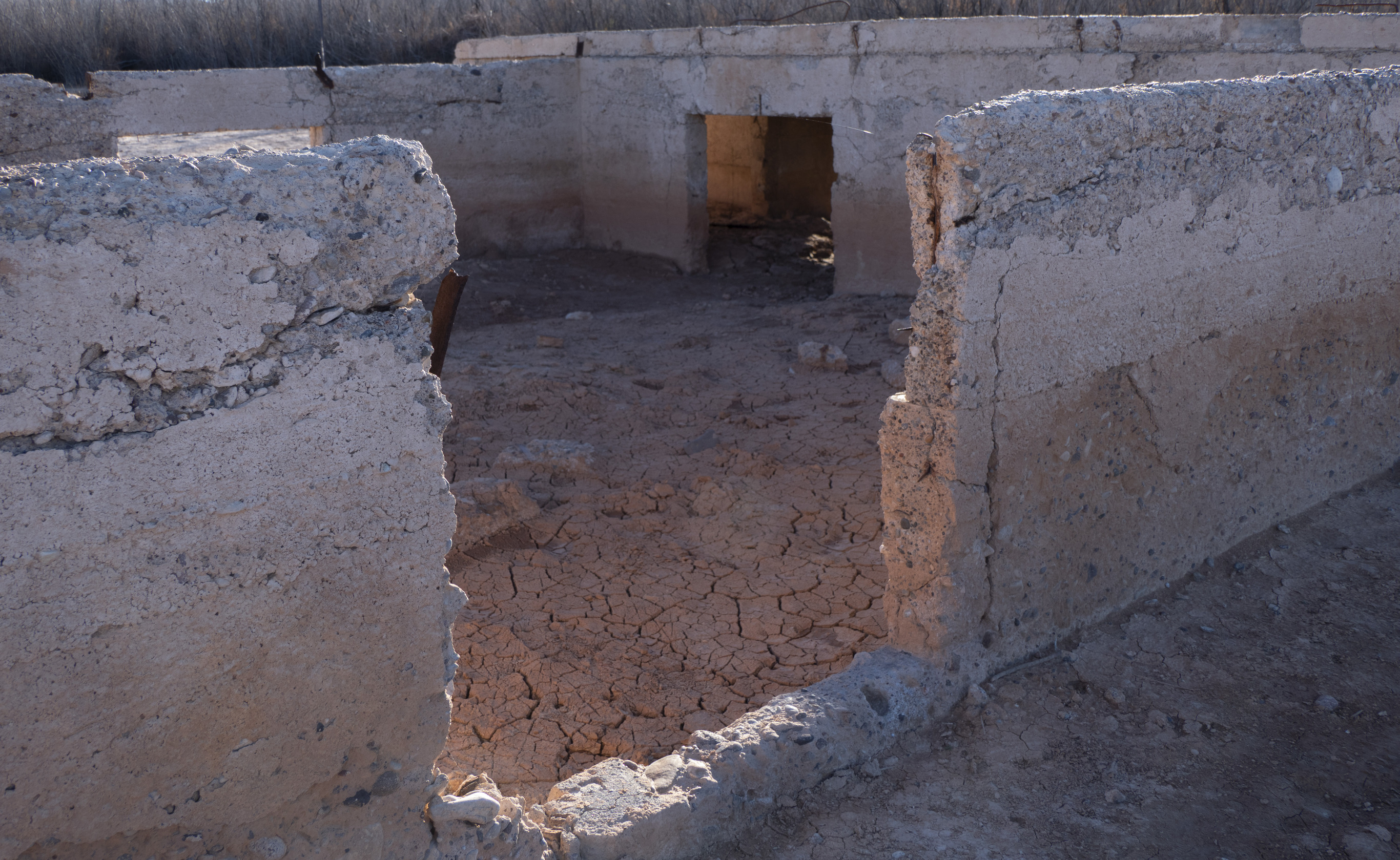 low view through rectangular opening of  waist high concrete foundation walls