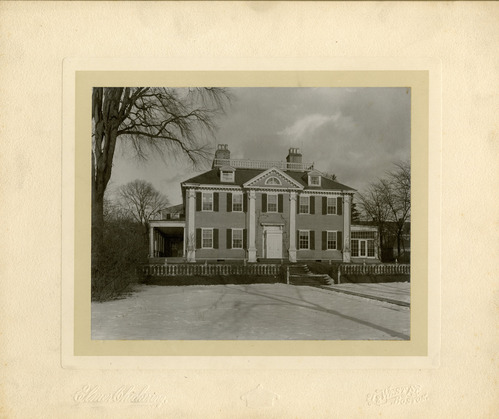 Facade of Georgian mansion, with snow on the ground. Black and white.