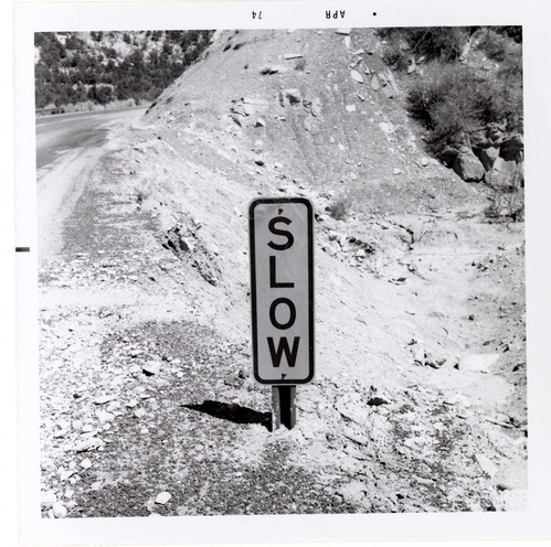 Road sign reading 'SLOW' in Kolob Canyon.