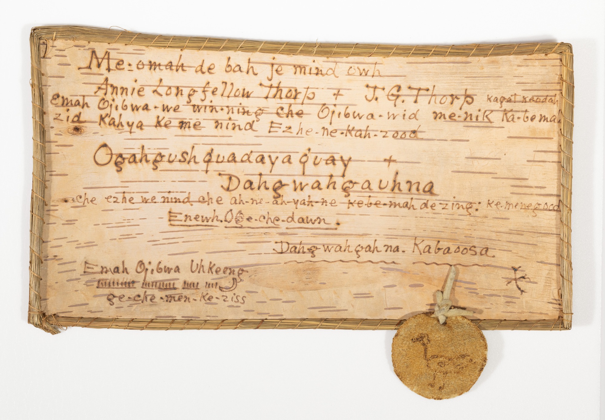 Birchbark certificate with adoptive name for Annie Longfellow Thorp and J.G. Thorp in Anishinaabemowin.