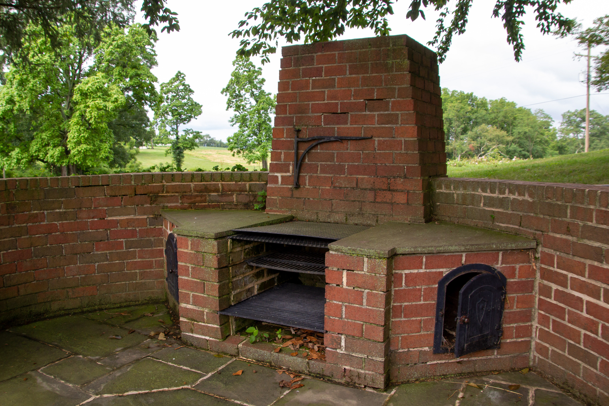 A historic brick outdoor fireplace and cooking stove.
