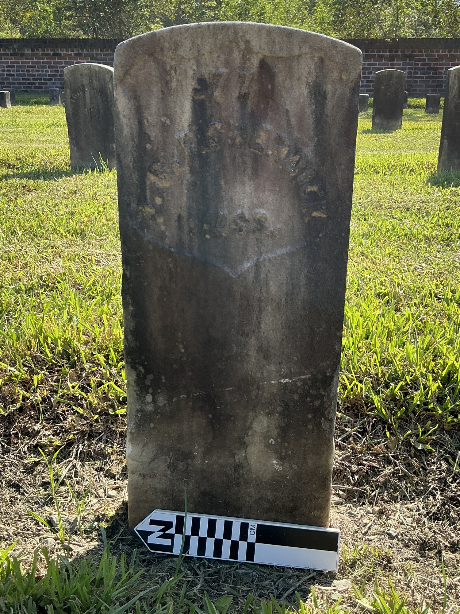 Extra image of historic upright marble headstone with recessed shield face.