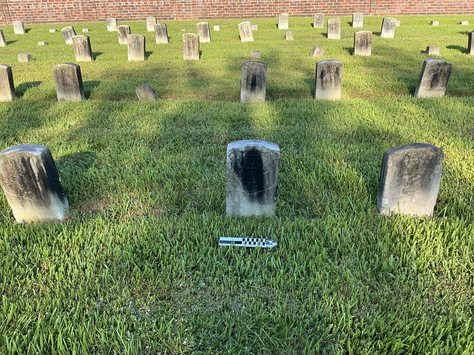 Extra image of historic upright marble headstone with recessed shield face.