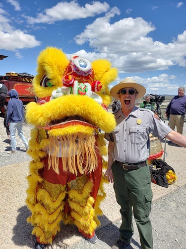 A very excited ranger poses with the Chinese Lion Dancer.