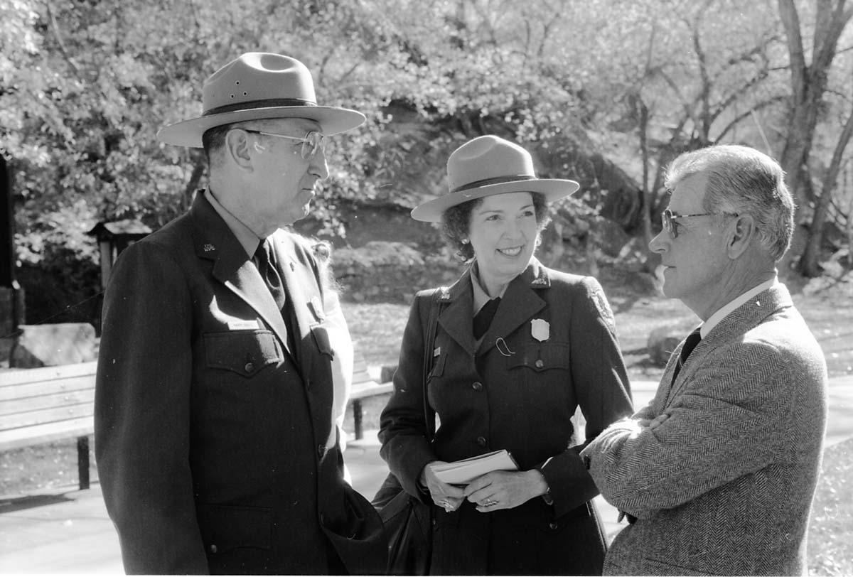 BW Photos of the Zion Lodge Rededication Ceremony. Superintendent Harold (Harry) Grafe speaking with man and woman.