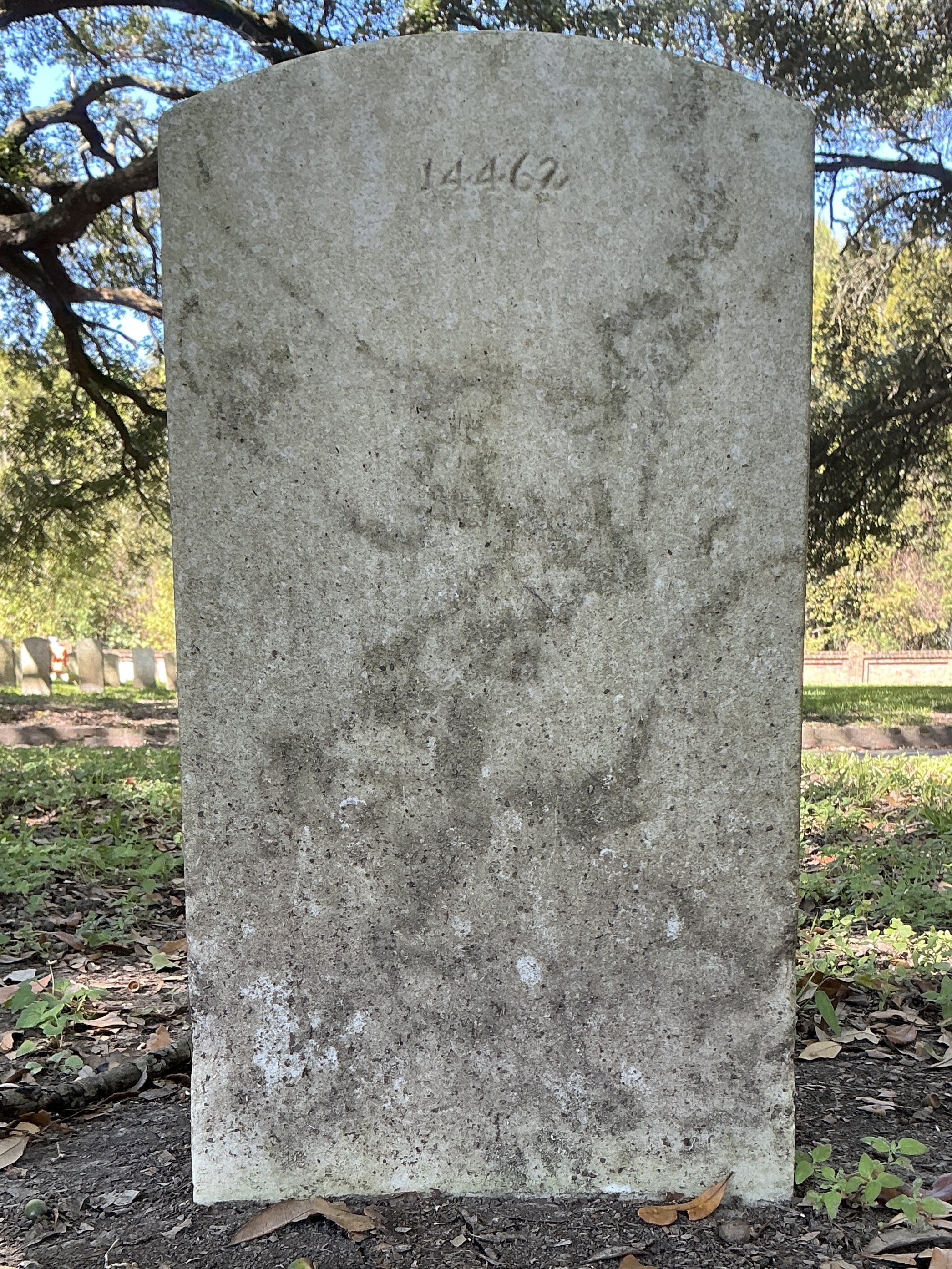Back of upright marble headstone with flat face.
