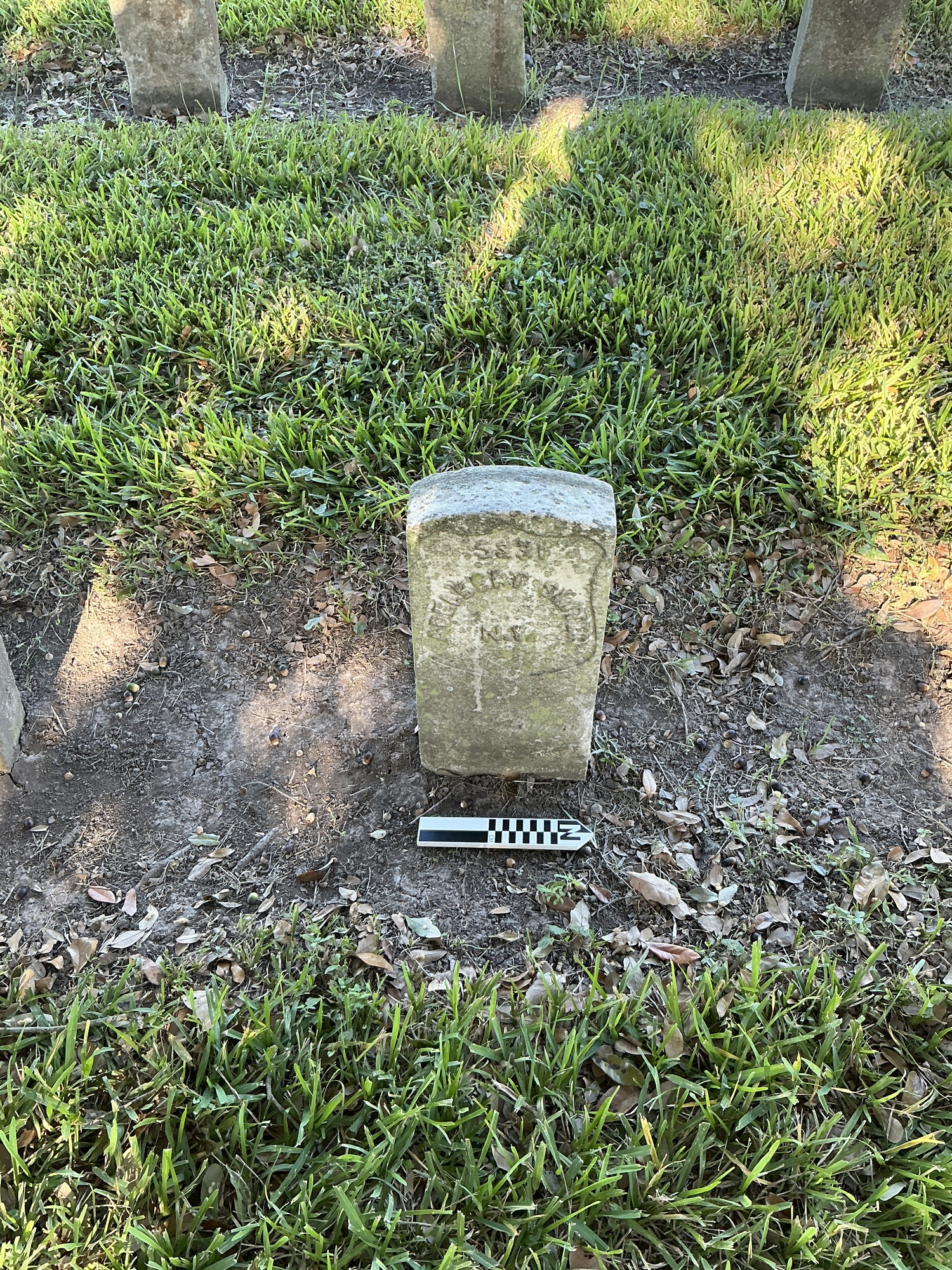 Extra image of historic upright marble headstone with recessed shield face.