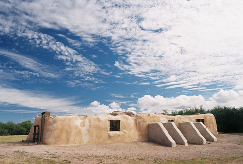 Mission convento fragment with buttresses and cloudy skies