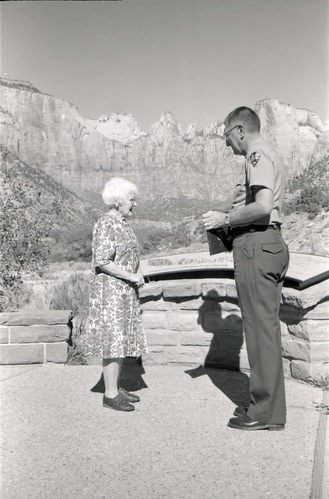 BW Photos of Superintendent Harold Grafe giving award to lady.