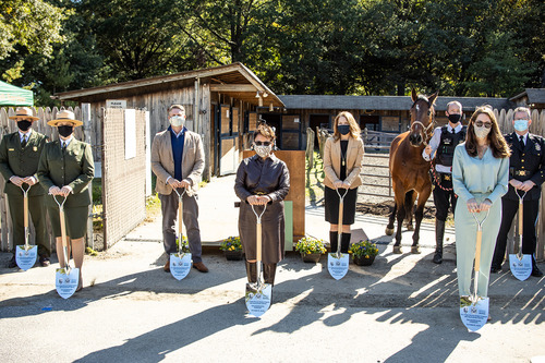 NPS staff, United States Park Police, and representatives from the Trust for the National Mall present shovels during the groundbreaking event for soon to be established horse stables on the National Mall. 