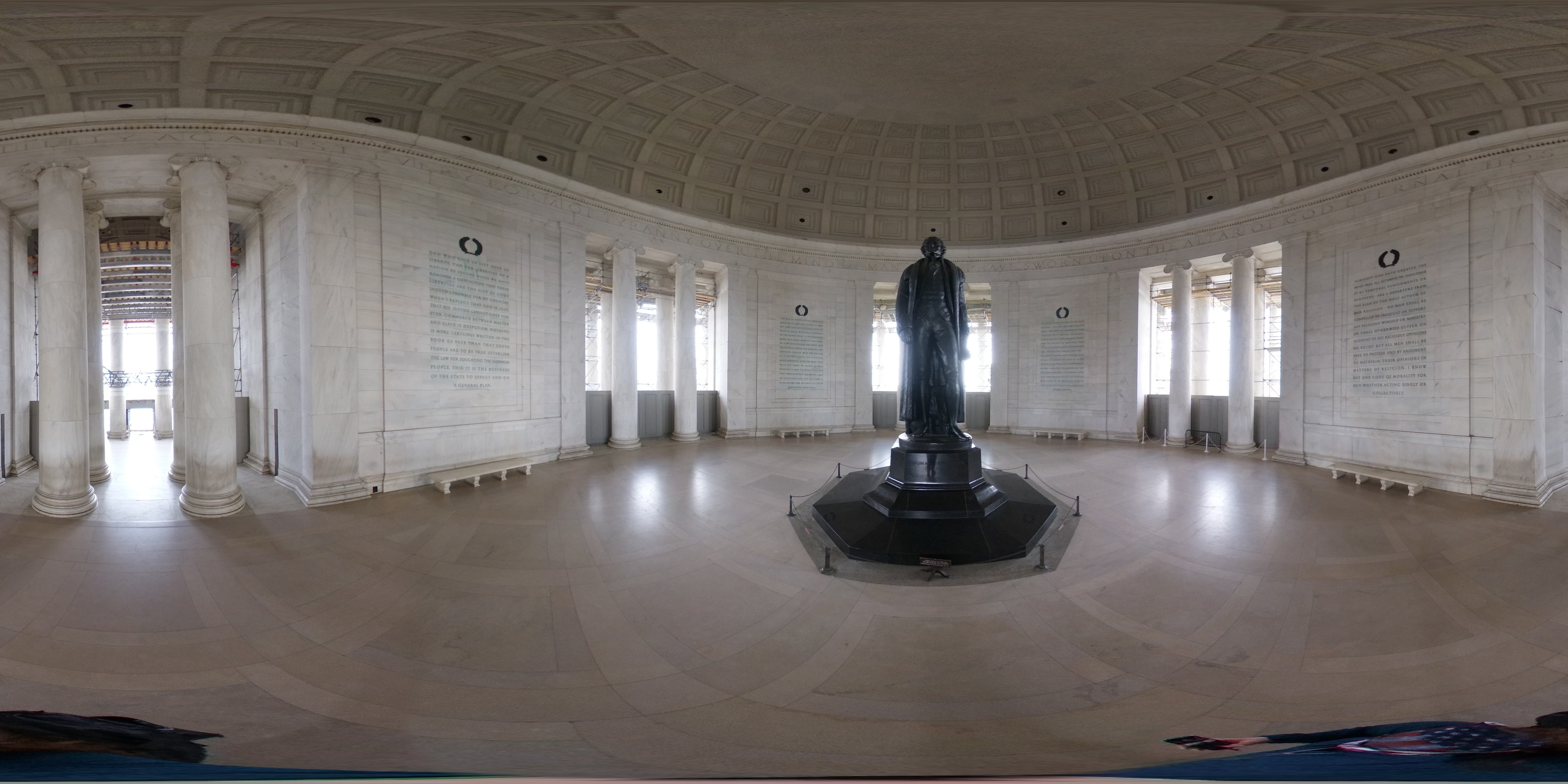 Spherical image of inside a circular memorial chamber that features a statue of Thomas Jefferson in the center. The exterior of the plaza features panels with Jefferson's writings and columns to outside.