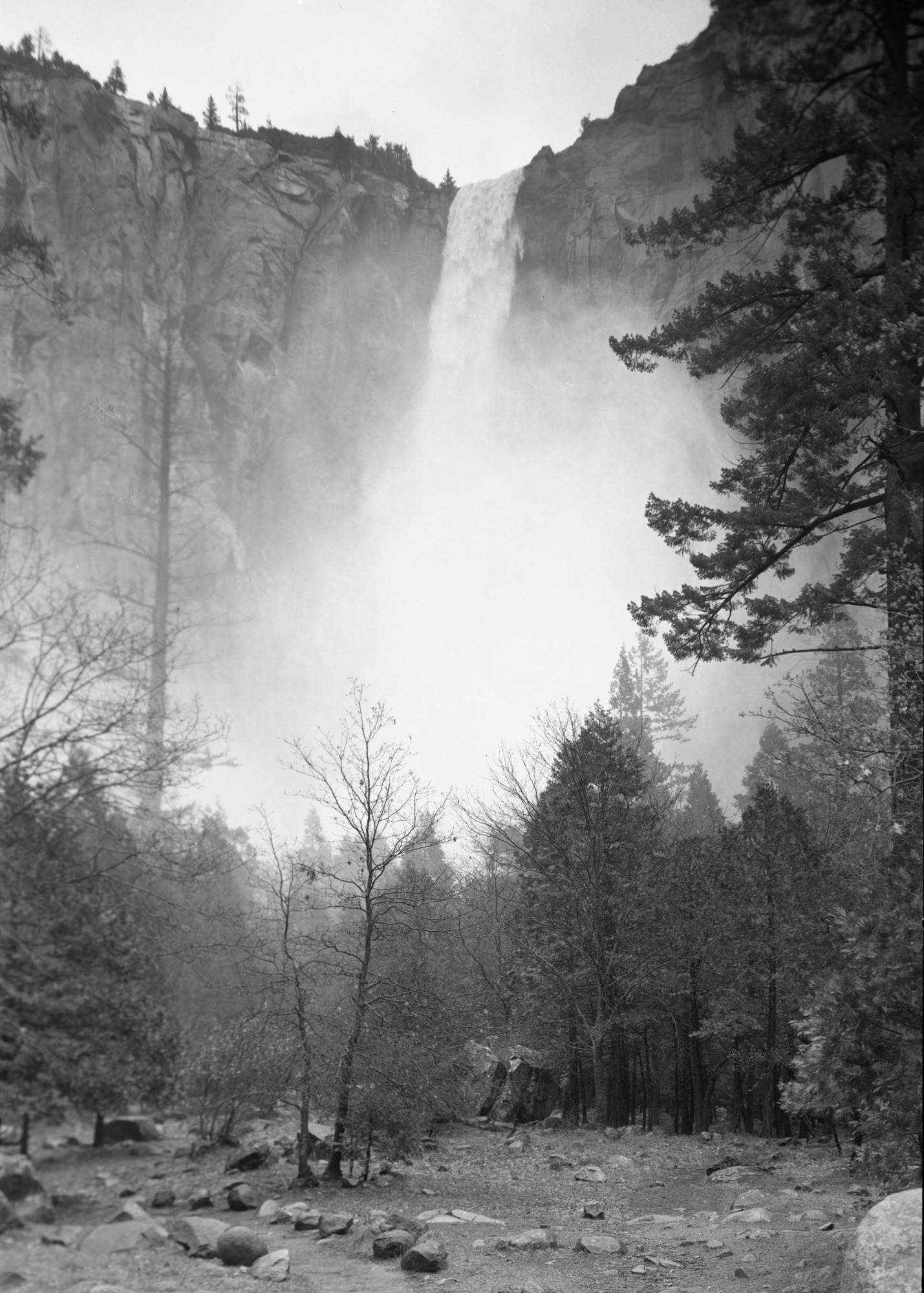 Bridalviel Fall running at full volume after heavy rain storm. Mist rises.