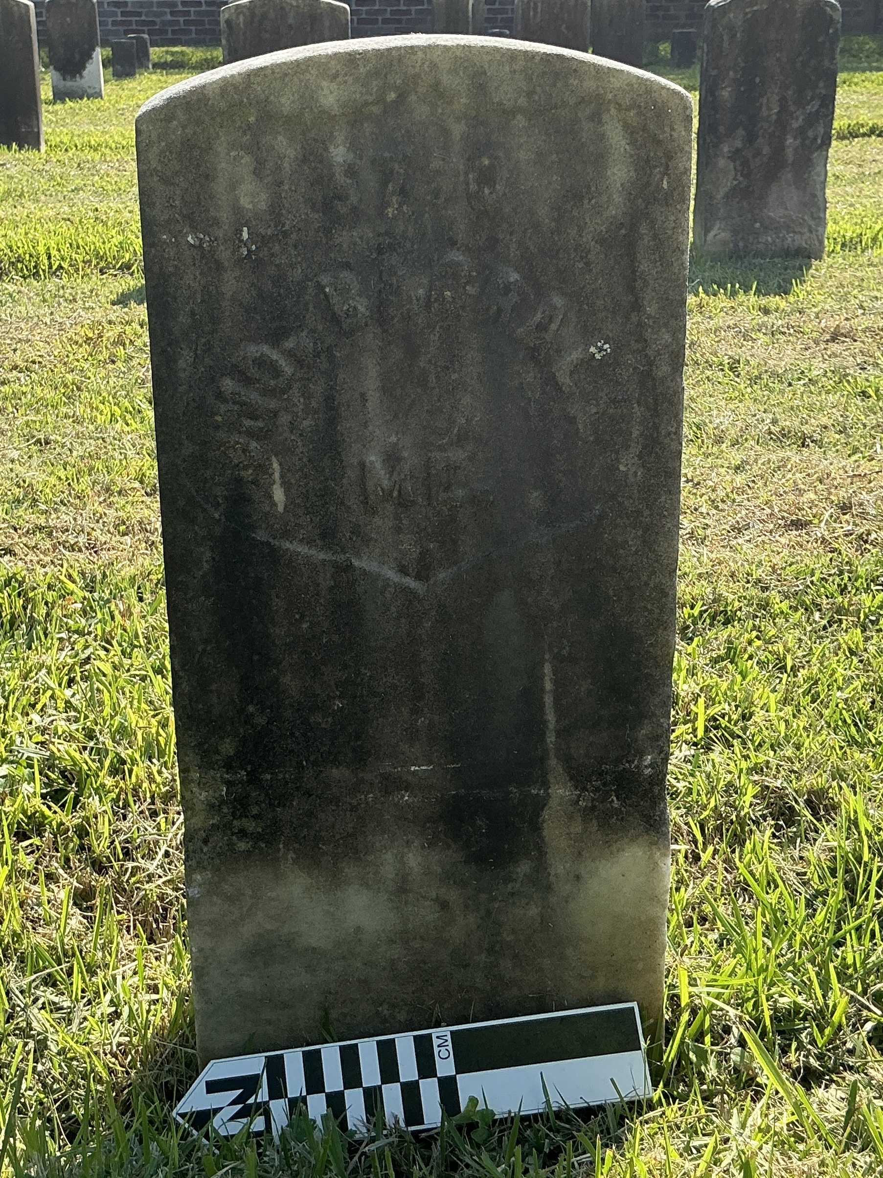 Extra image of historic upright marble headstone with recessed shield face.