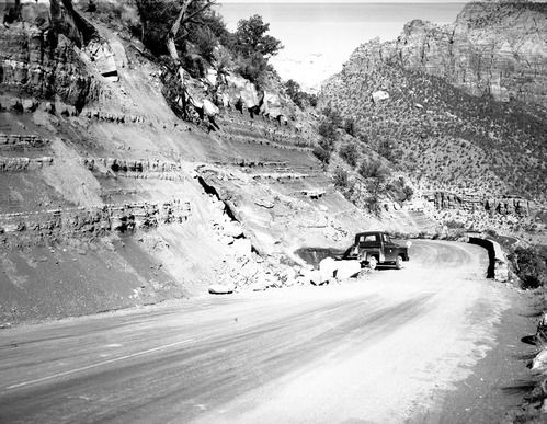 Rock fall on switch back road. 50-ton boulder slid onto roadway [scratches, pits]