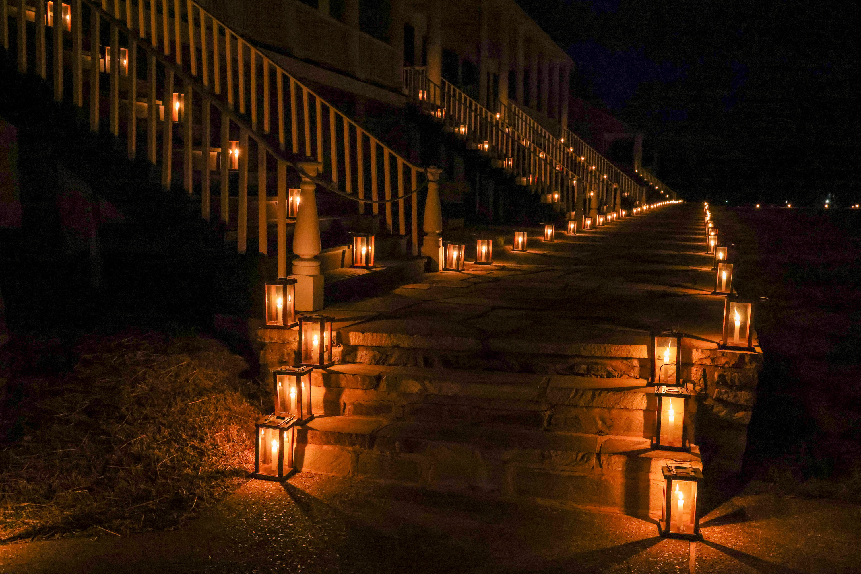 Candlelight illuminates the walkway in front of and up the stairs of Fort Scott's historic officers' quarters. The many near parallel lines of light draw the viewers eye around the photo. In person, the effect is rather magnified.