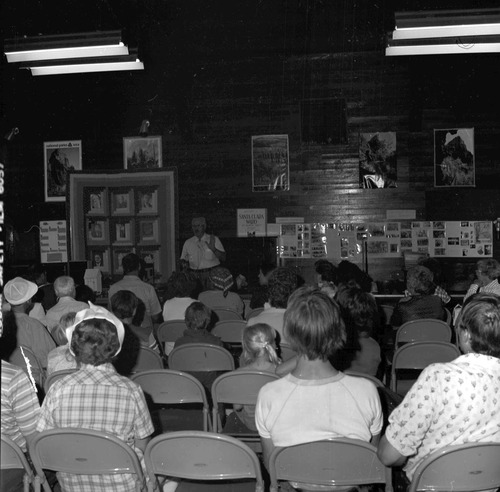 Visitors listening to Owen Sanders tell stories at the second annual Folklife Festival, Zion National Park Nature Center, September 1978.