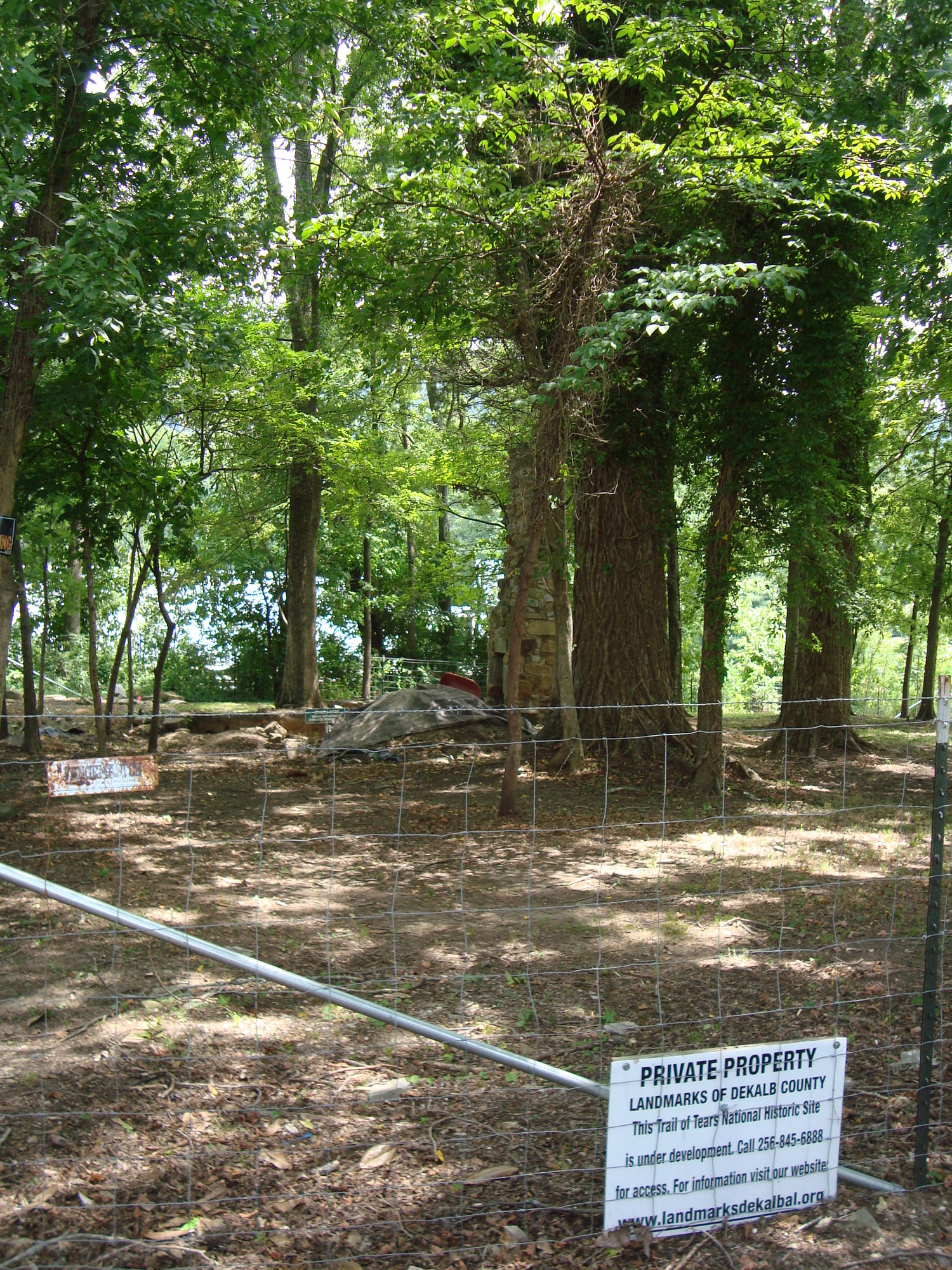 A fence and sign marks Private Property - Landmarks of DeKalb County at Fort Payne Cabin Historic Site in Fort Payne, Alabama