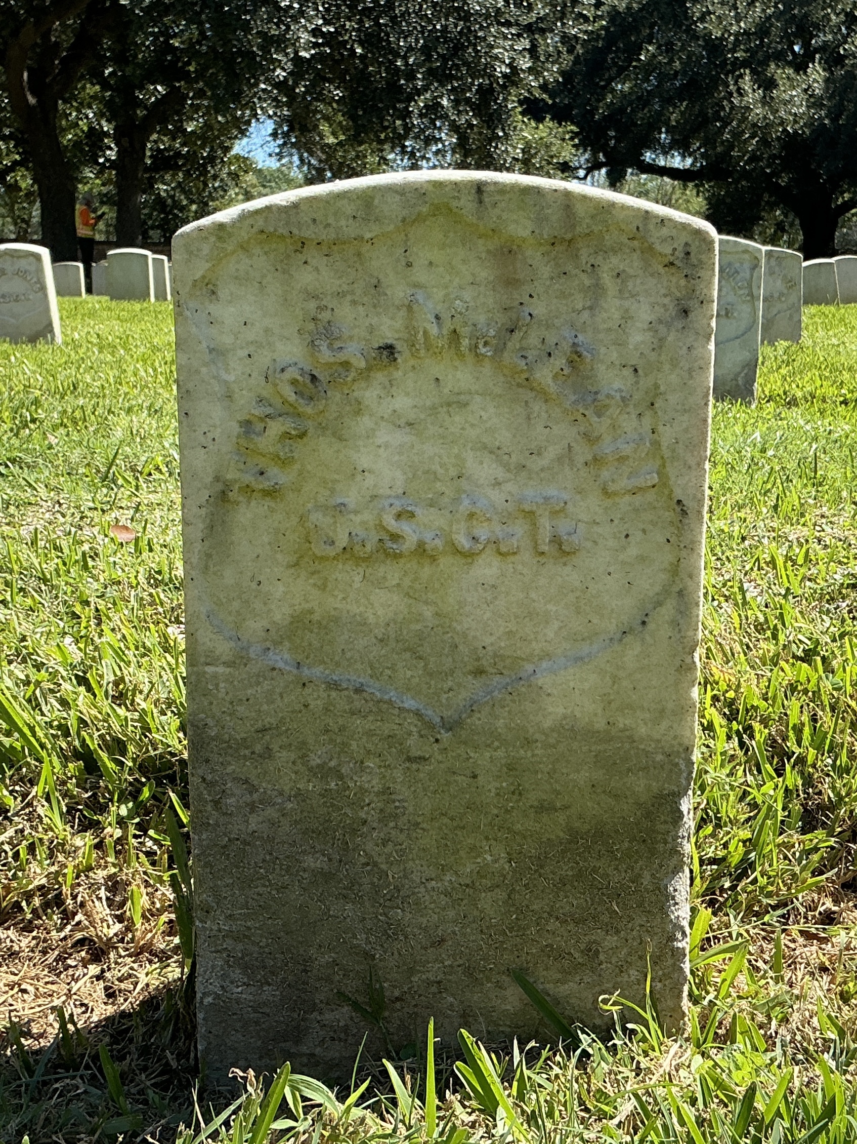 Back of historic upright marble headstone with recessed shield face.