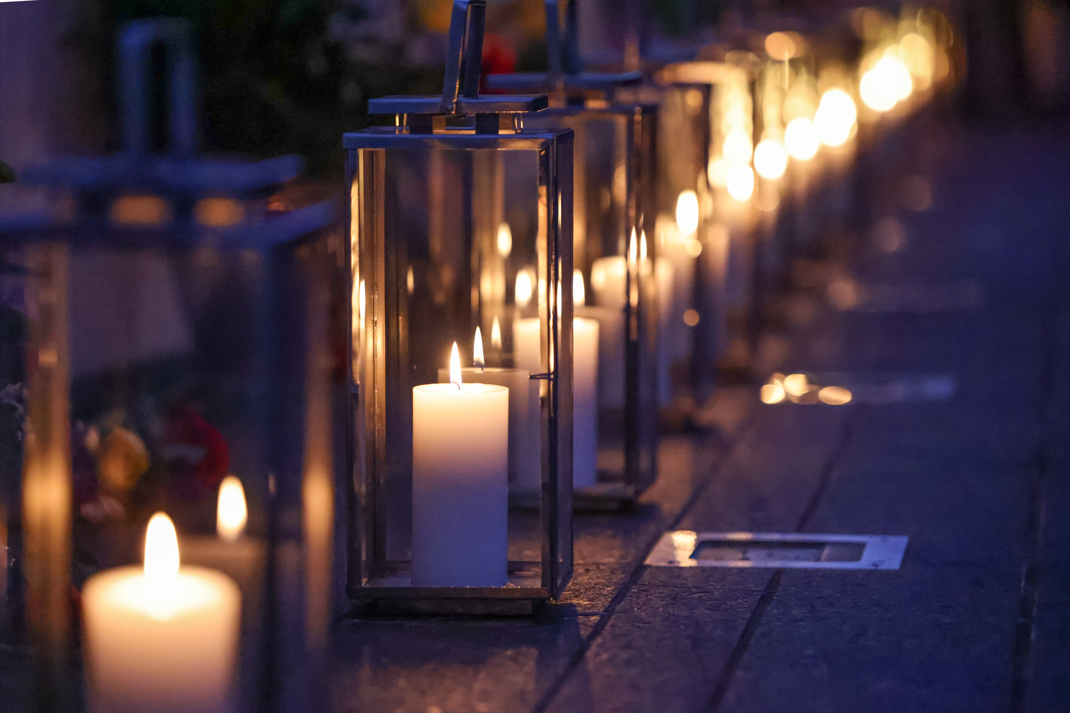 Lanterns are placed at the Wall of Names.