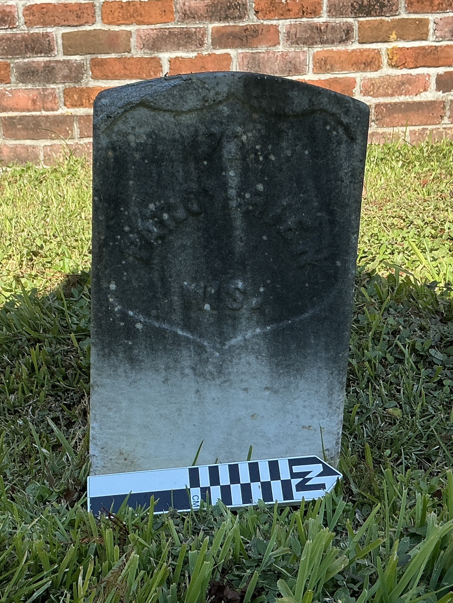 Extra image of historic upright marble headstone with recessed shield face.