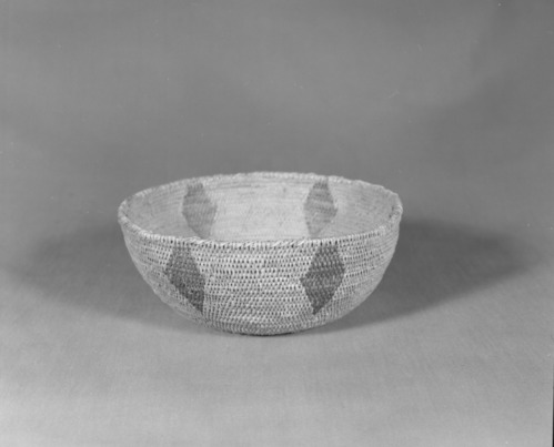 Private Collection. Object: Miwok basket. Dimensions: 7 x 3". Materials: Redbud, unidentified split shoot material, which is quite thick, probably ceanothus sp. Technology: Single rod, fag ends trimmed on work face, moving ends trimmed on interior. Leftward coil direction, rim overstitched. Collection History: Made by Matilda, a Sonora Miwok, c. 1920. Photographed by Michael Dixon. Catalogued by Craig Bates and Barbara Beroza. Yosemite Collections, National Park Service.