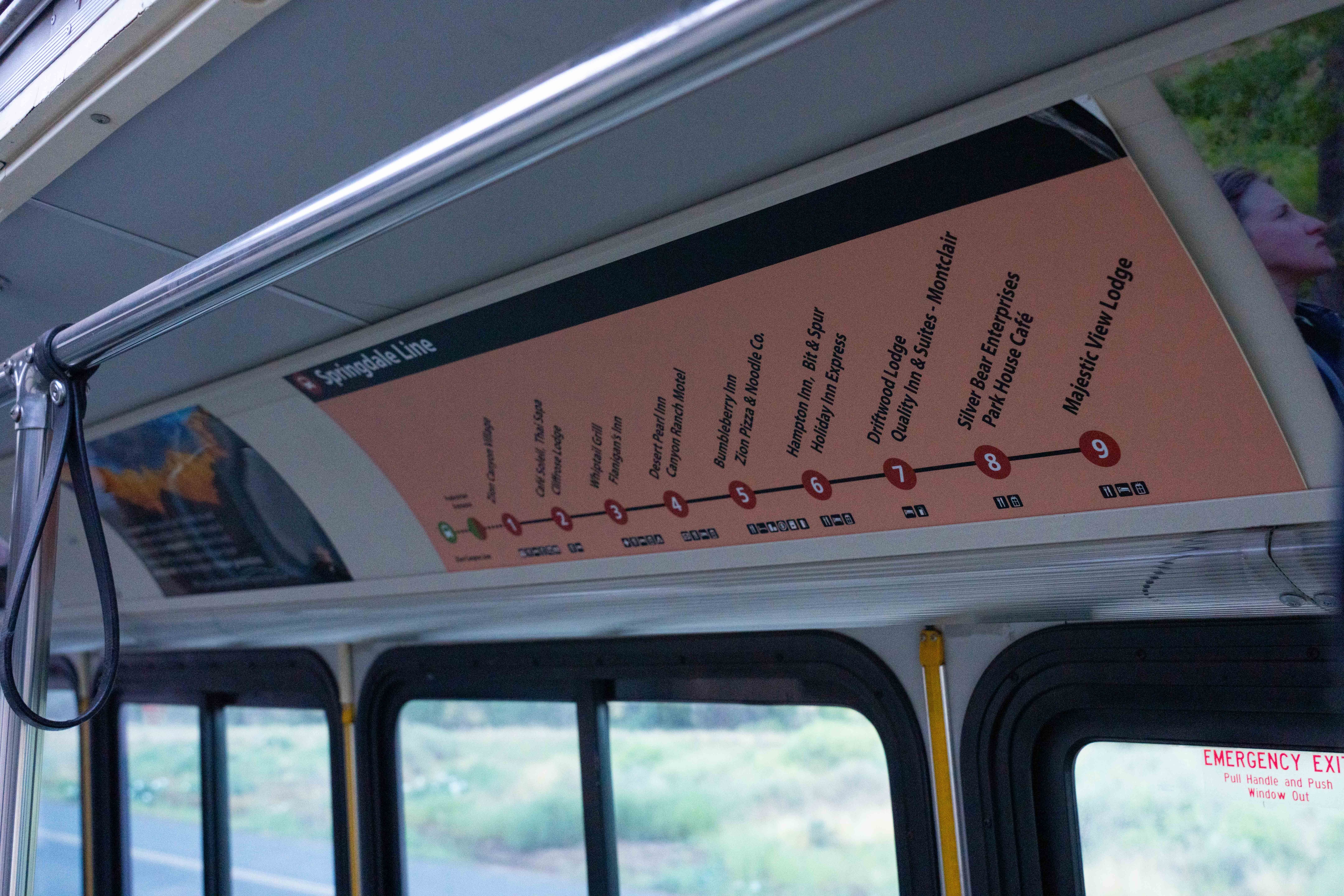 Close up photo of multiple signs that are on display inside the Zion shuttle buses above the windows.