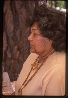 The profile of a woman in a Native American attire.