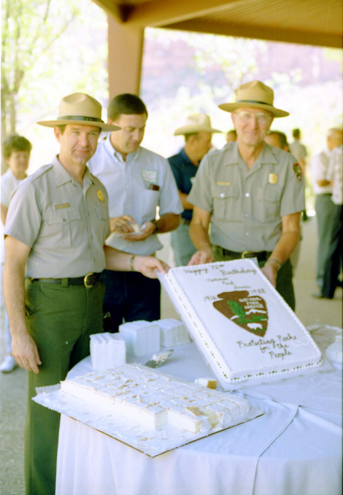 Color Photos of the parks 72nd anniversary celebrations- cake cutting, barbecue, speakers.
