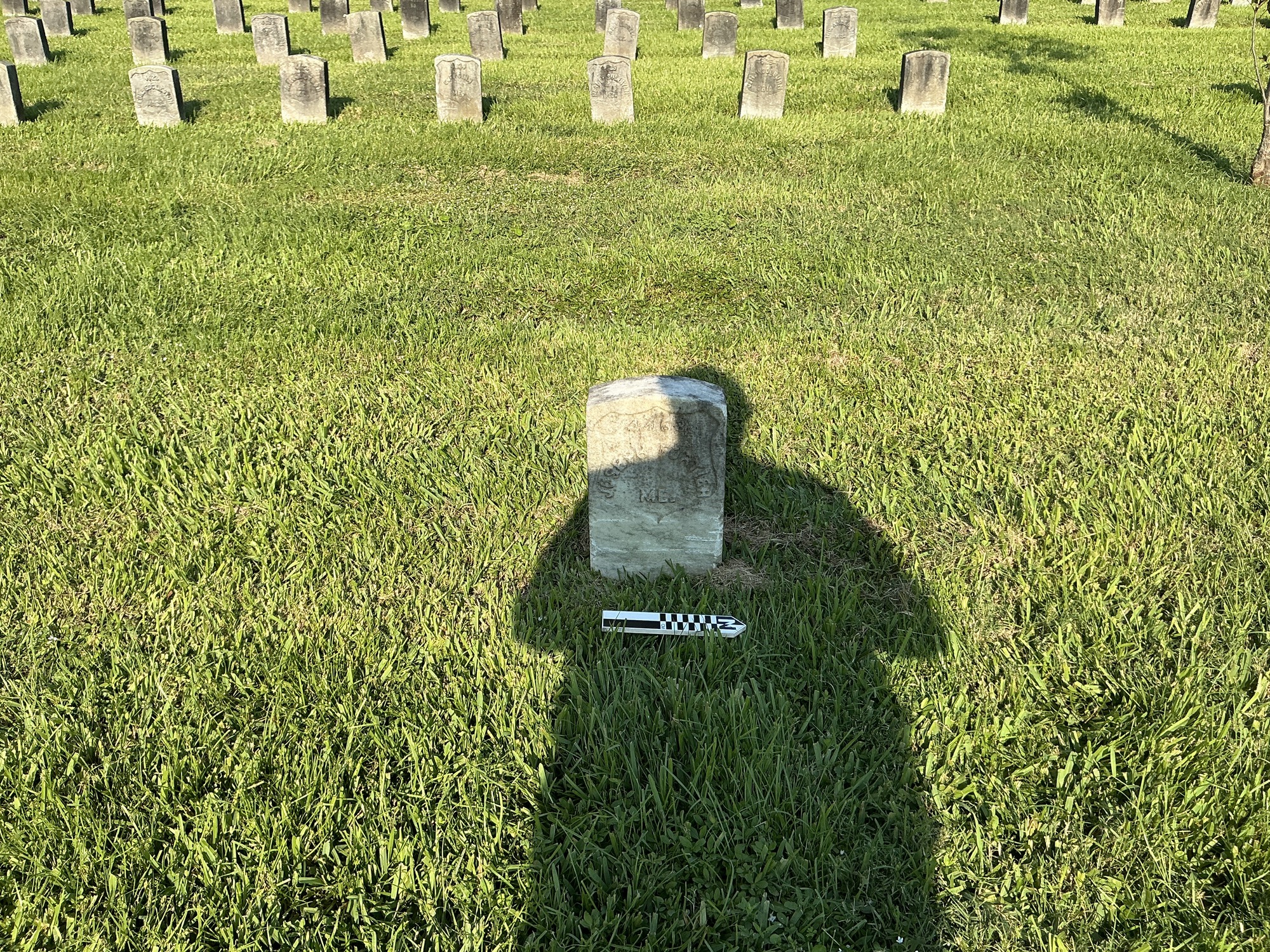 Extra image of historic upright marble headstone with recessed shield face.