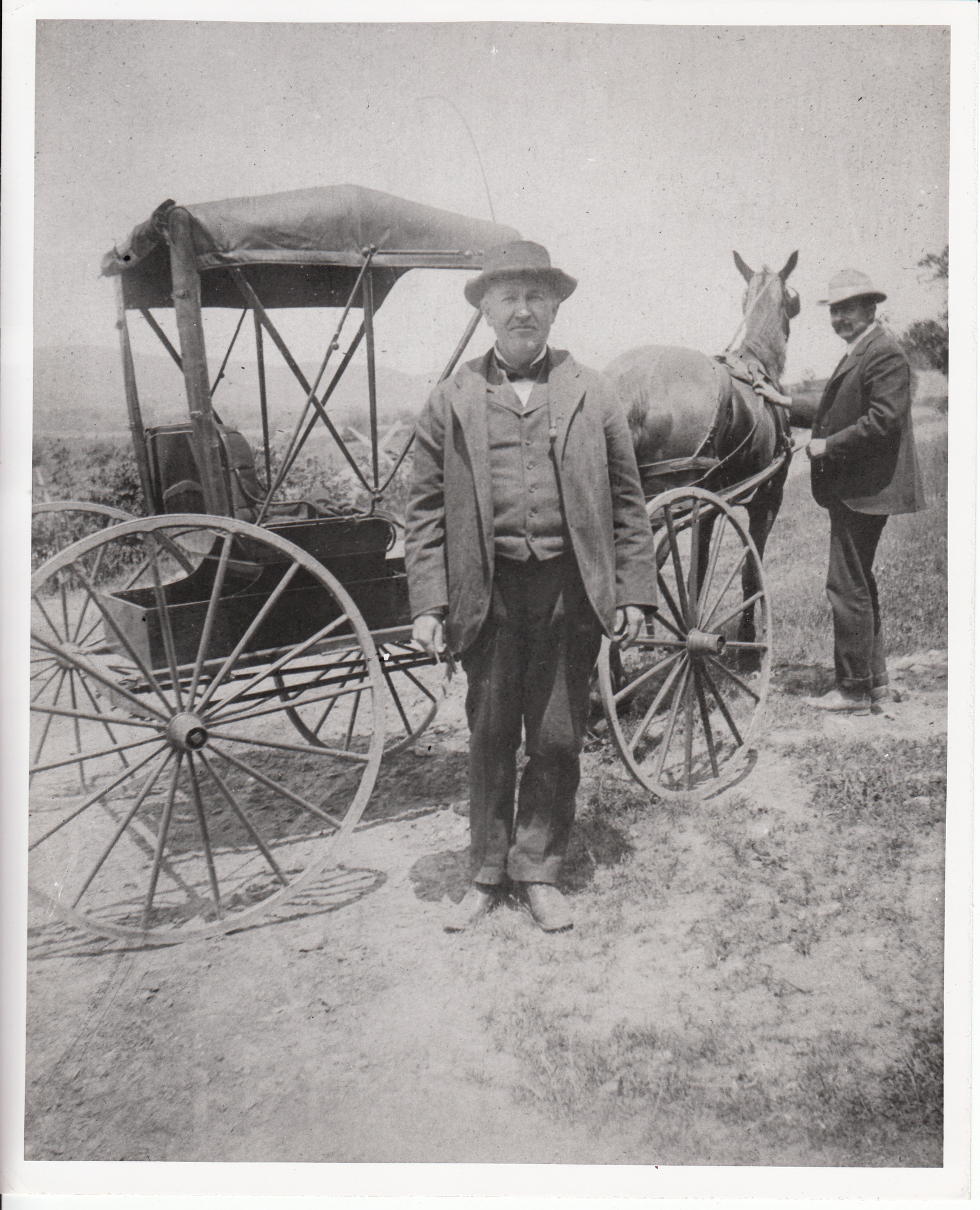 Thomas Edison and driver beside horse and buggy.