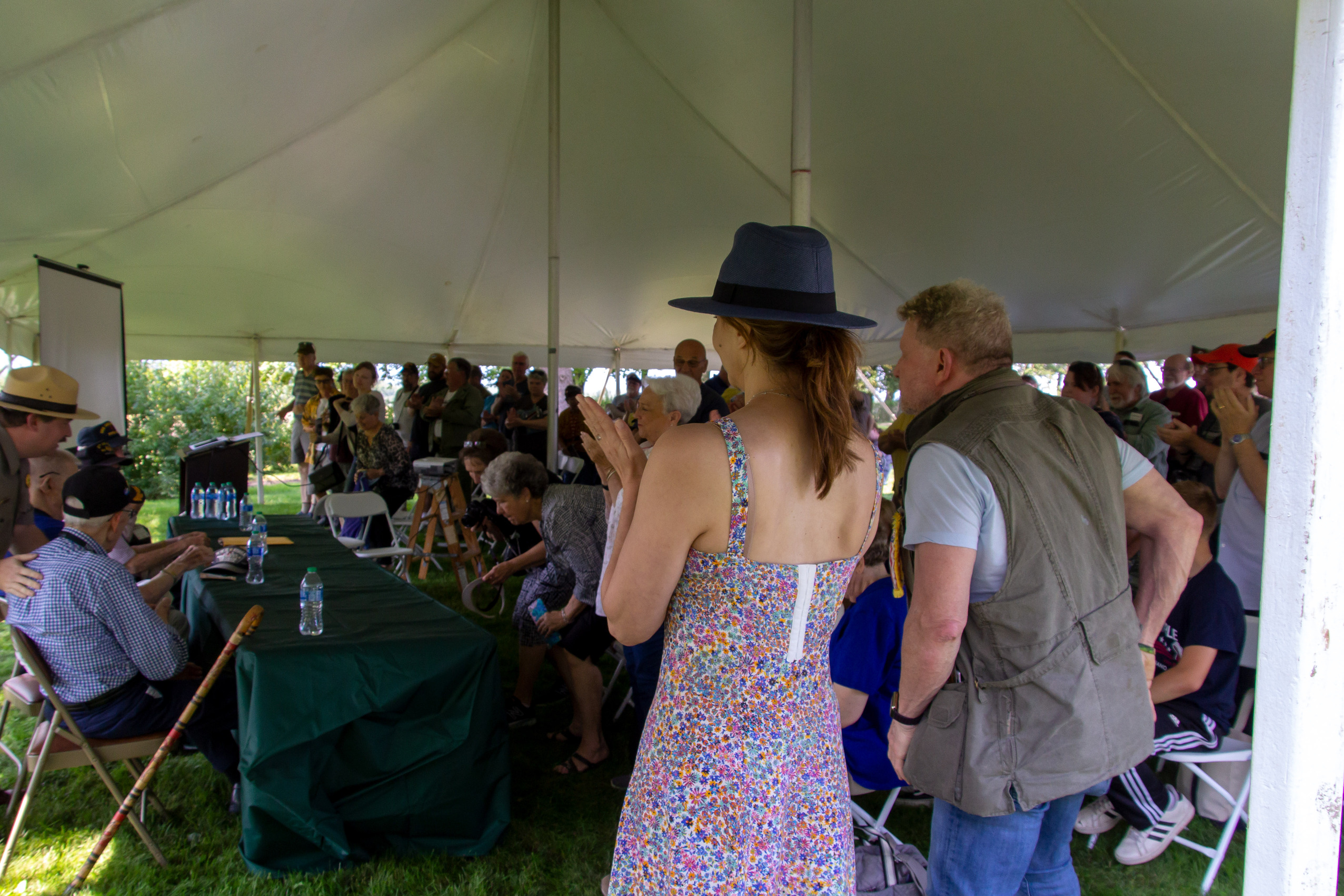 An audience claps for the World War 2 veterans.