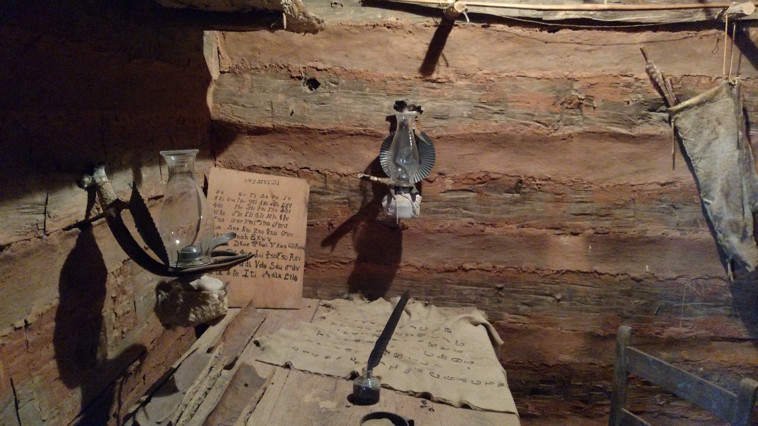 A room in a log cabin with a wooden floor.