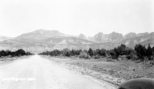 Kolob peaks looking west of Highway 91 (I-15) on road to new harmony toward peaks. Fender in foreground of frame.