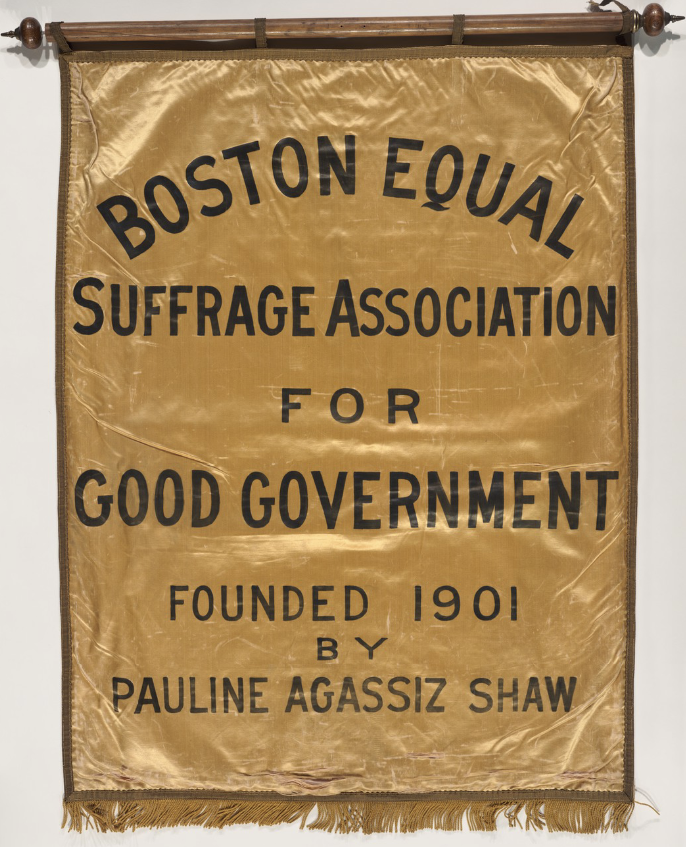 Gold Banner that reads "Boston Equal Suffrage Association for Good Government founded 1901 by Pauline Agassiz Shaw."