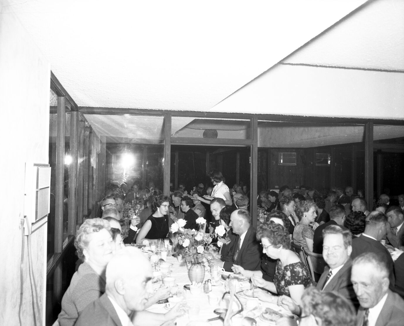 Men and women eating dinner at retirement party for Superintendent Paul R. Franke. Party held at the Driftwood Lodge, Springdale, Utah.