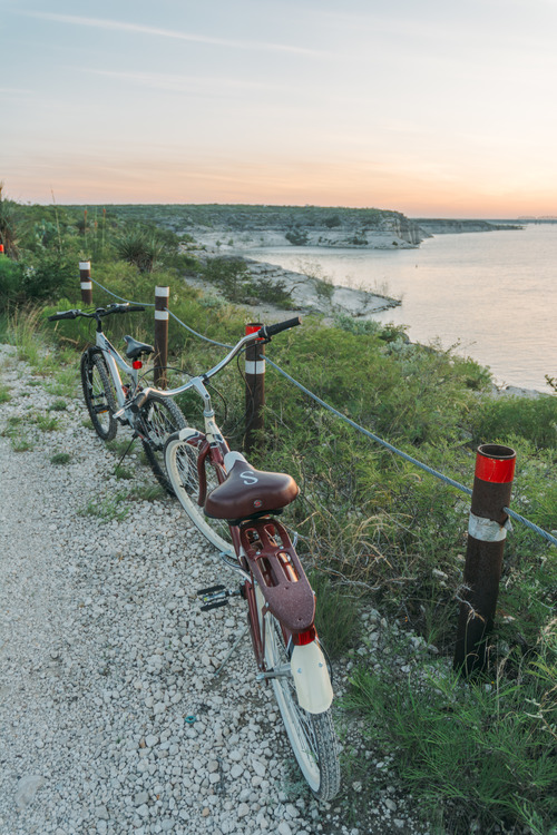 Bikes parked along the road near the lake