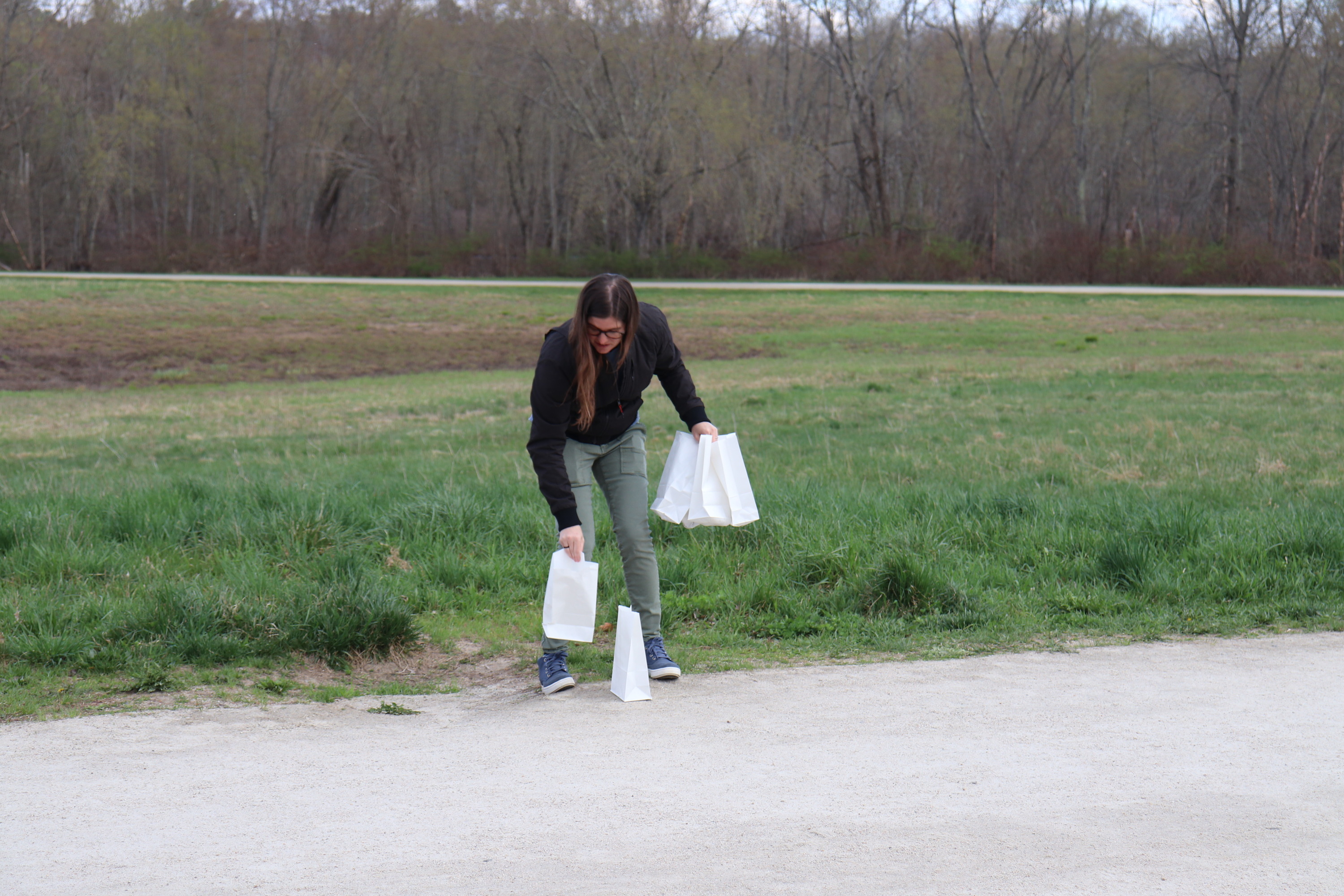 Park Volunteers, laying out lanterns along the road to the North Bridge. 