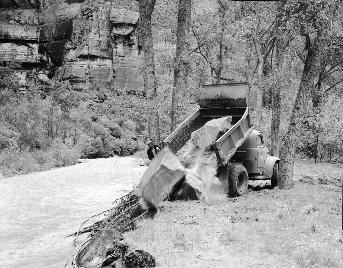 Hauling rocks for revetment work to control Virgin River flood damage by erosion protection works.