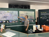 A ranger pointing to an orientation map.