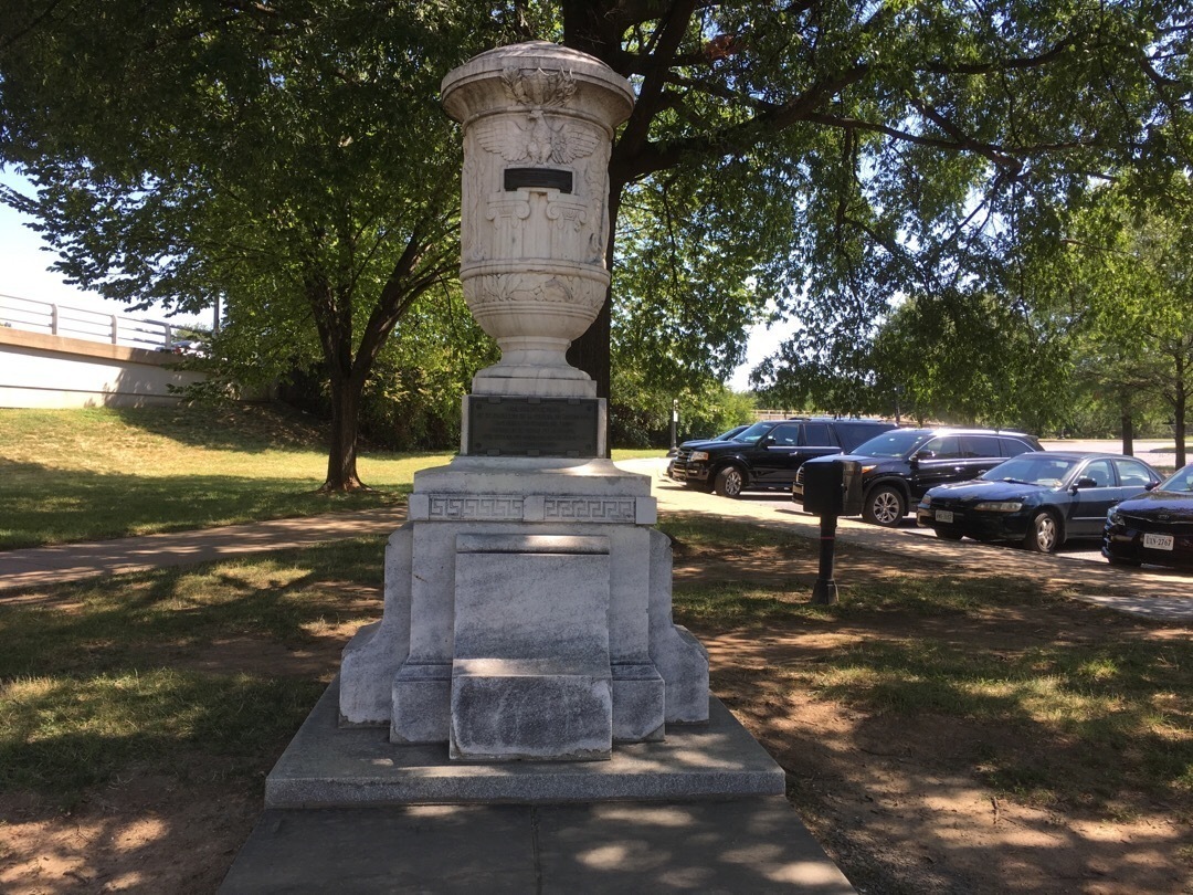 A marble urn on a stone pedestal.