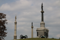 3 monuments and two cannon on a hill