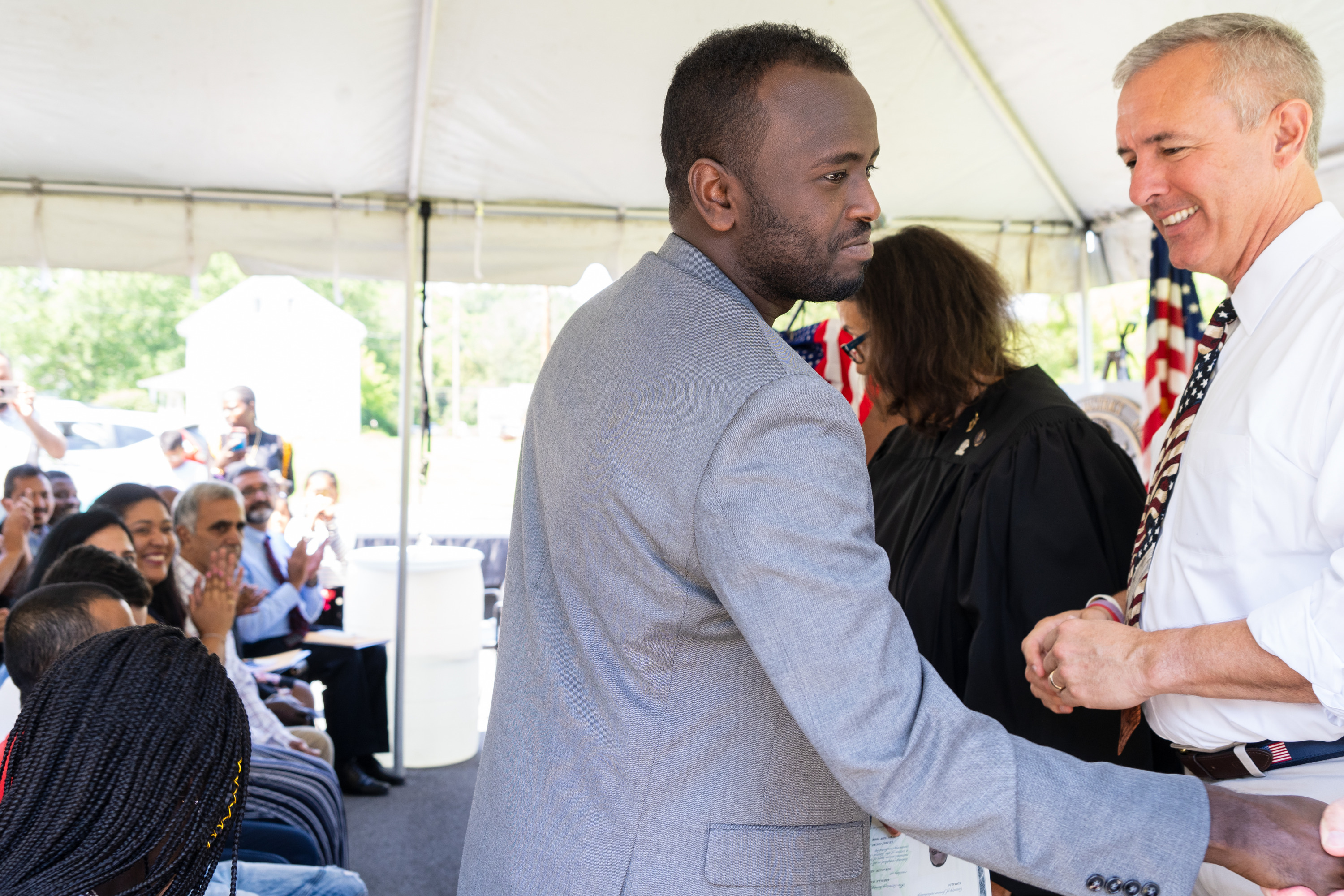 A man receives a certificate and a hand shake.