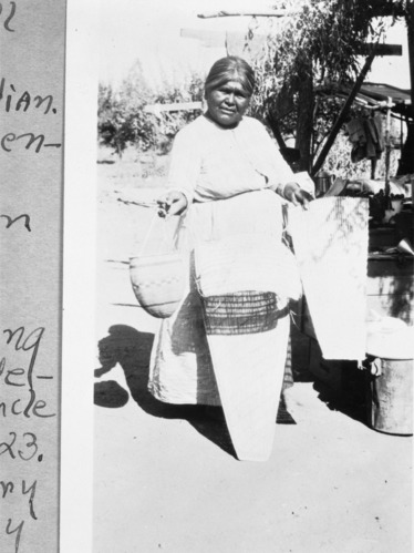 Copy Neg: April 2001, L. Radanovich. Maggie Icho, Wukchumne Yokuts with baskets she made. Copied from the Frank Latta photo collection in the Yosemite Museum.