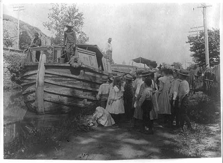 Historical black and white photo of a group of children on a school field trip to the C&O Canal.