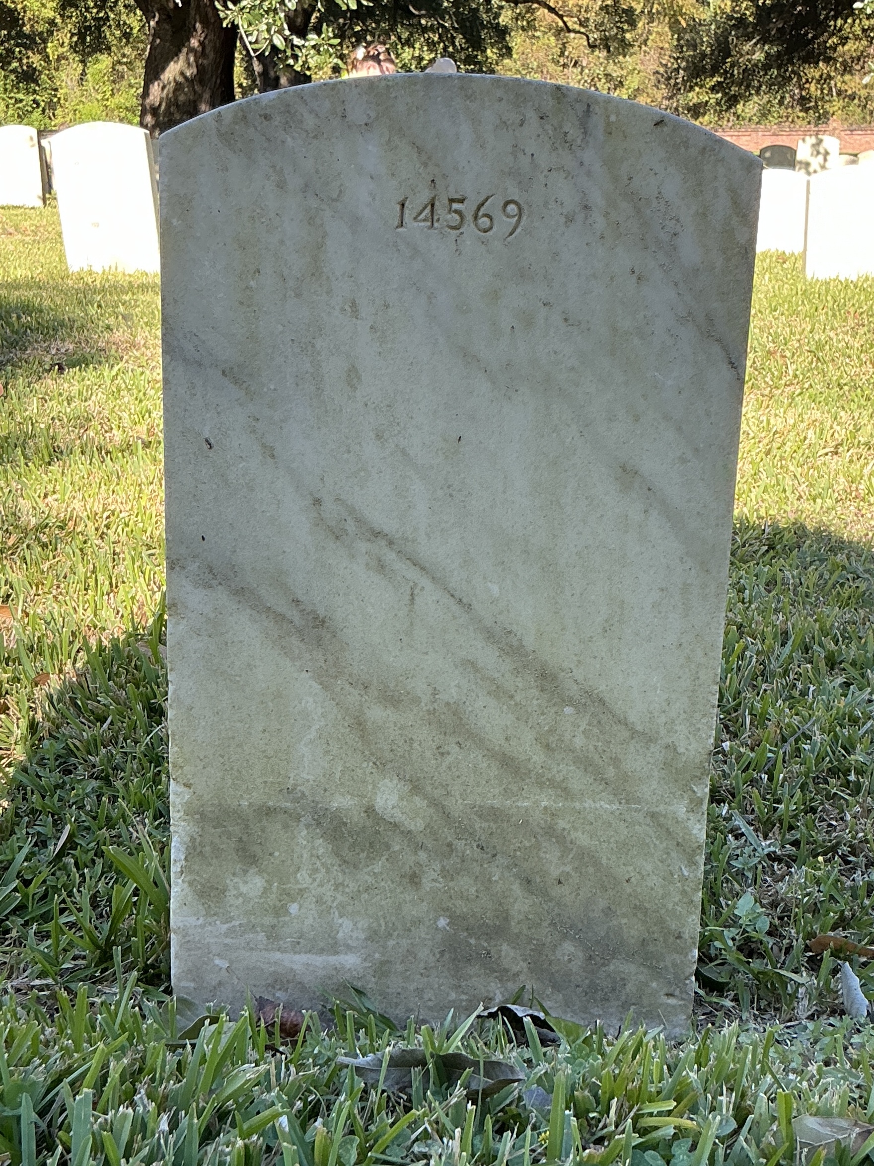 Back of upright marble headstone with flat face.