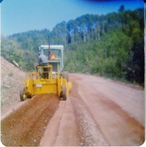 Man operating construction vehicle performing road work along the Kolob Terrace Road.