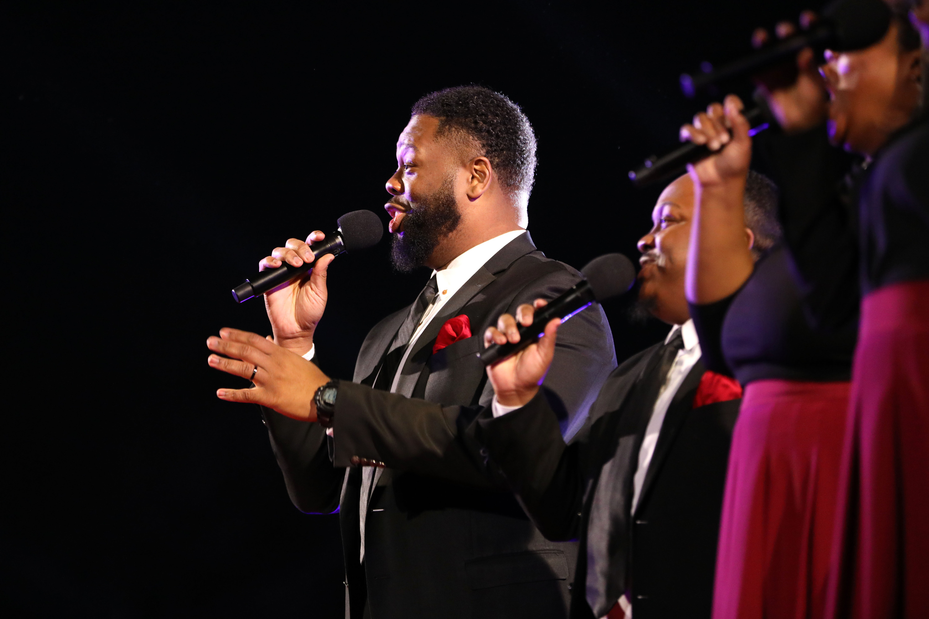 Four backup vocalists singing during Spensha Baker's performance at the National Christmas Tree Lighting 