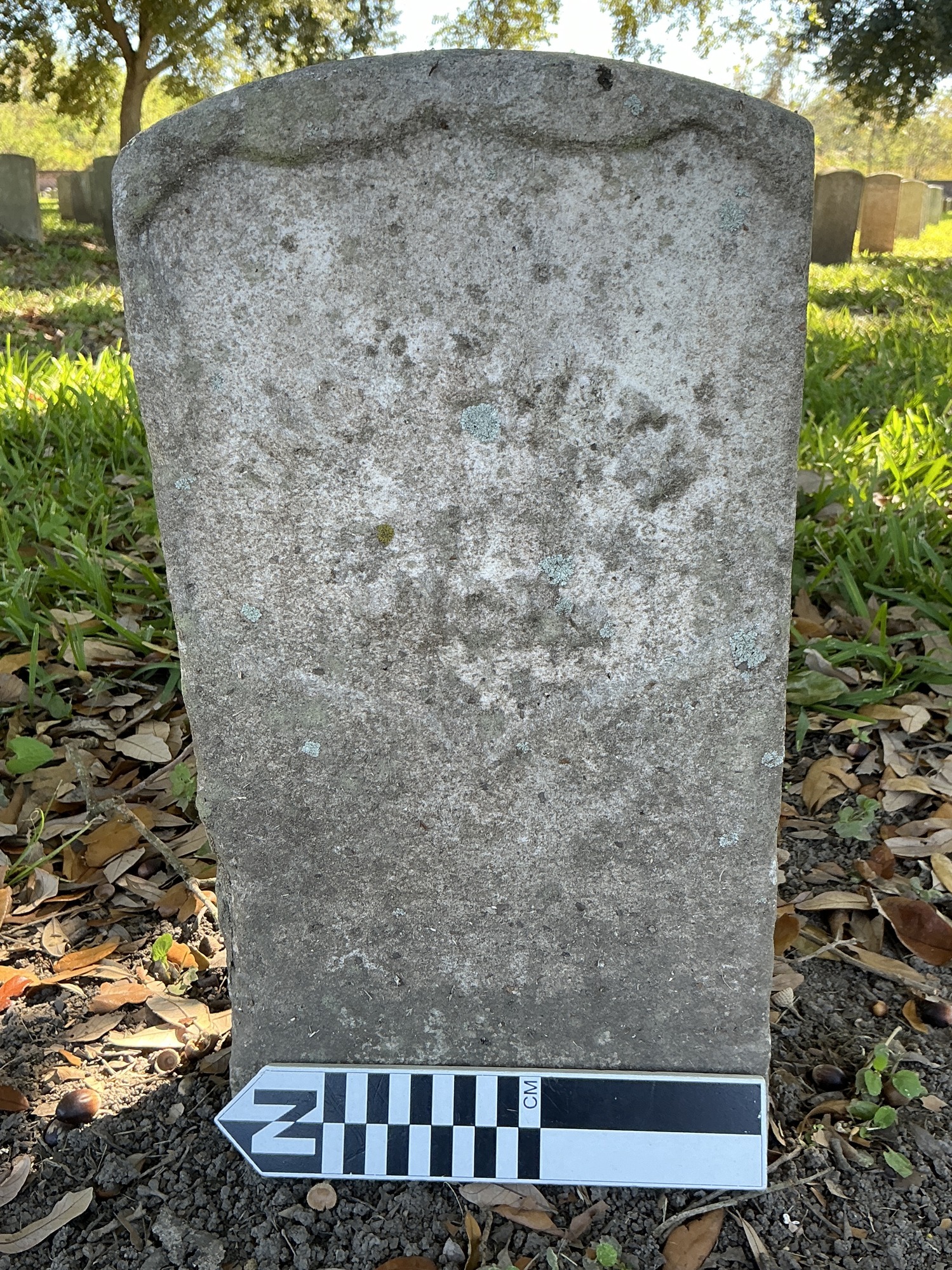 Extra image of historic upright marble headstone with recessed shield face.