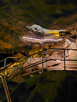 A large staircase climbs higher in the cave. 